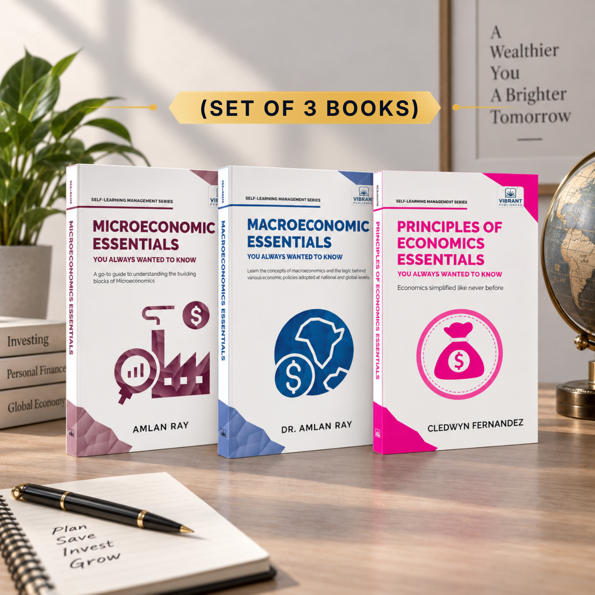 Three economics books from the Self-Teaching Management Series displayed on a wooden desk with a notebook, pen, and plant in the background. The books are titled 'Microeconomic Essentials', 'Macroeconomic Essentials', and 'Principles of Economics Essentials' by Amlan Ray and Cledwyn Fernandez.